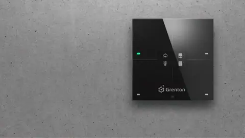 Grenton touch panel set flush into a concrete wall