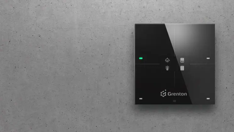 Grenton smart-home touch panel mounted on a raw concrete wall