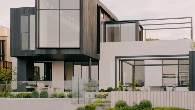 Contemporary white and timber house with a shaded pergola and landscaped garden